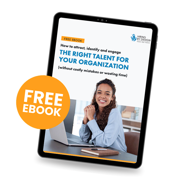 Promotional graphic for a free Hiring By Design ebook displayed on a tilted tablet mockup against a black background. An orange circle overlapping the left side of the tablet reads “FREE EBOOK” in large white text. The ebook cover features the Hiring By Design logo in the top right and the headline: “How to attract, identify and engage THE RIGHT TALENT FOR YOUR ORGANIZATION (without costly mistakes or wasting time).” The bottom half of the cover shows a smiling woman in a light blue blouse sitting at a desk with a laptop, hands clasped, looking at the camera. The overall design uses white, blue, and orange brand colors. Promotional graphic for a free Hiring By Design ebook displayed on a tilted tablet mockup against a black background. An orange circle overlapping the left side of the tablet reads “FREE EBOOK” in large white text. The ebook cover features the Hiring By Design logo in the top right and the headline: “How to attract, identify and engage THE RIGHT TALENT FOR YOUR ORGANIZATION (without costly mistakes or wasting time).” The bottom half of the cover shows a smiling woman in a light blue blouse sitting at a desk with a laptop, hands clasped, looking at the camera. The overall design uses white, blue, and orange brand colors.